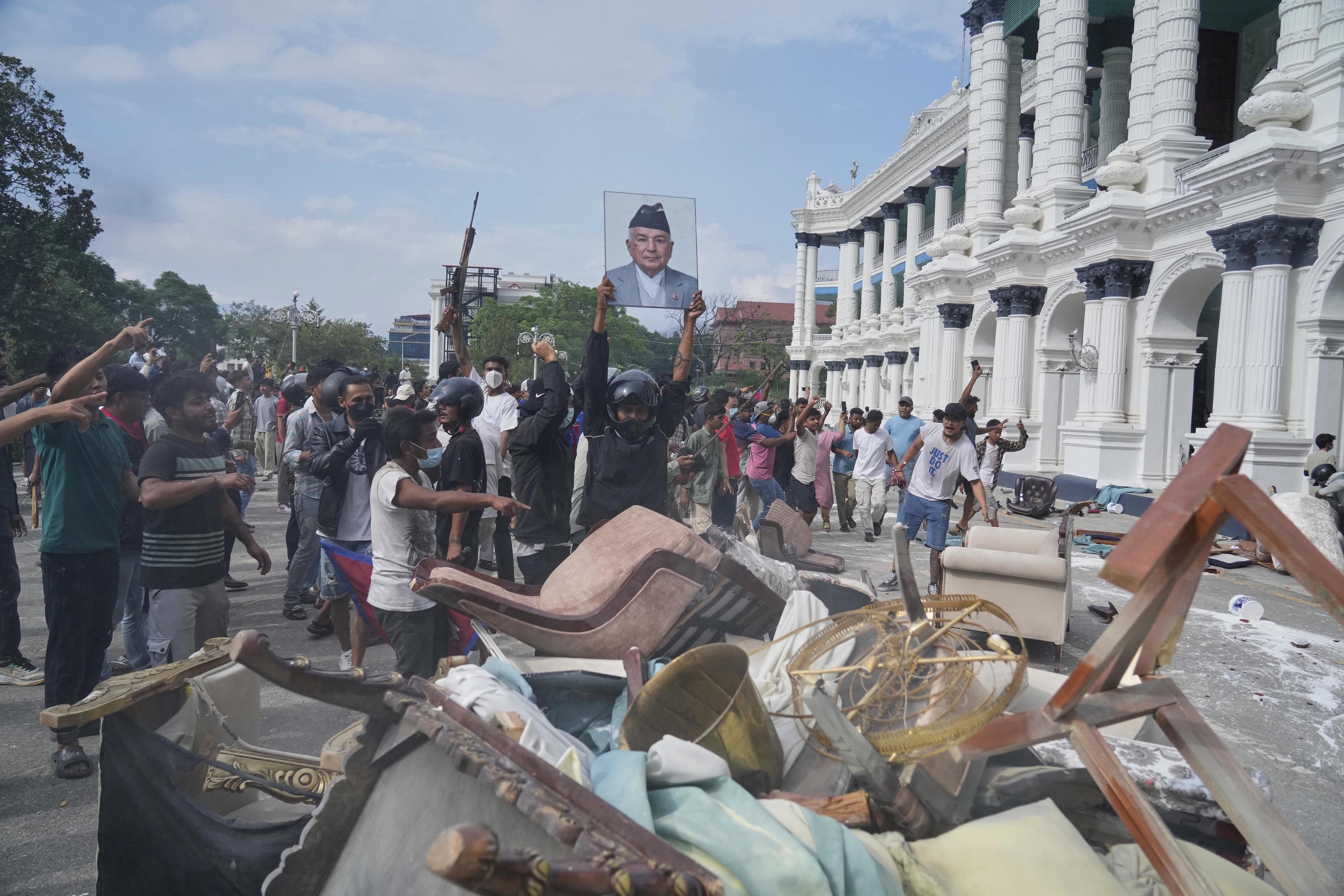 A protester throws a photograph of Nepal Prime Minister Khadga Prasad Oli.