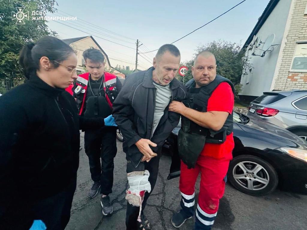 Paramedics provide medical help to an injured man after a Russian strike in Zhytomyr region