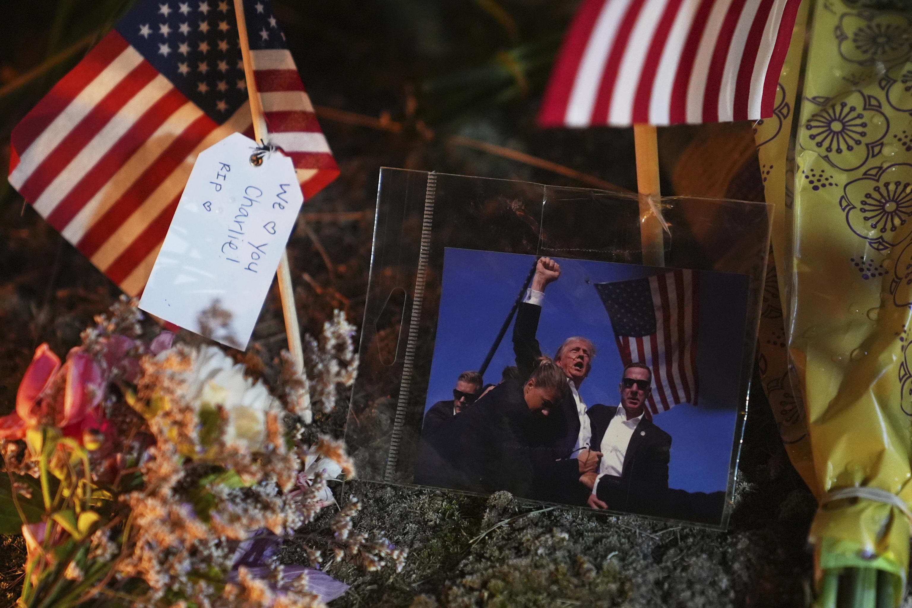 A photo of President Trump is seen at a growing memorial for Charlie Kirk.