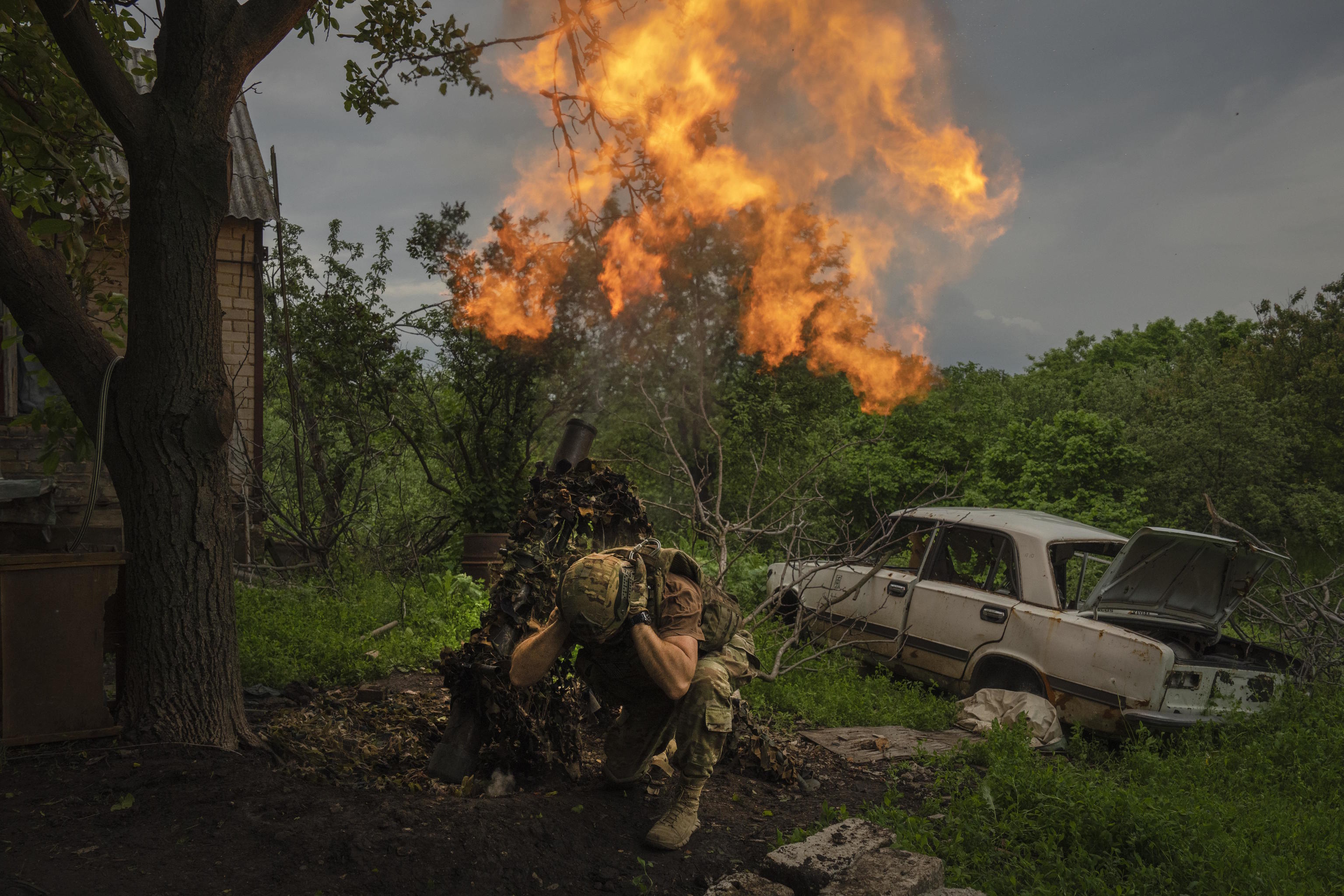 A Ukrainian soldier fires a mortar at Russian positions near Bakhmut.