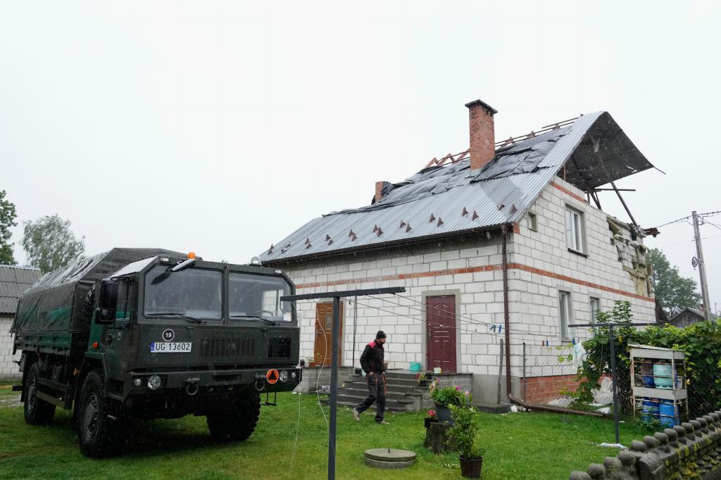 A man walks past a damaged house, after Russian drones violated Polish airspace