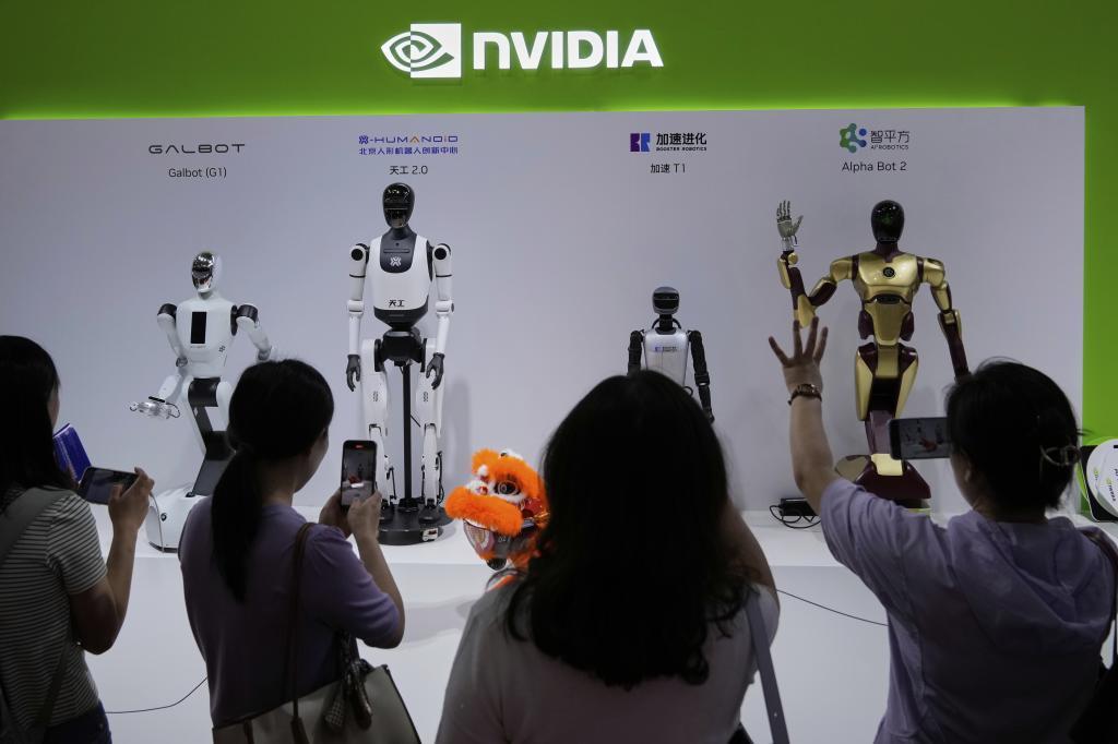 Visitors give commands to a robot at an Nvidia booth.