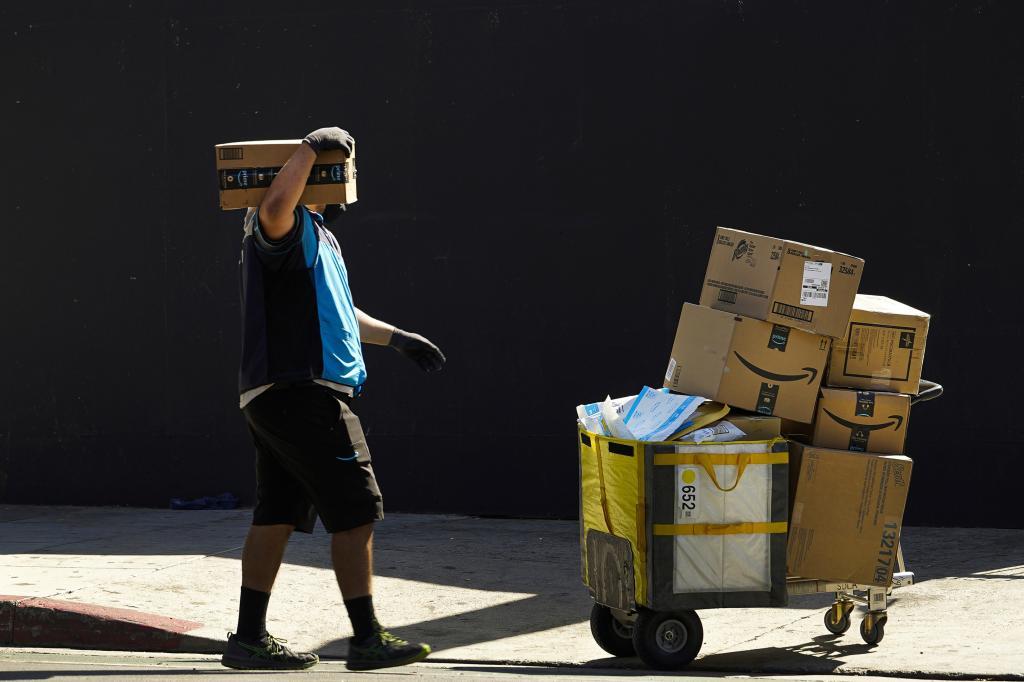 An Amazon worker delivers packages in Los Angeles