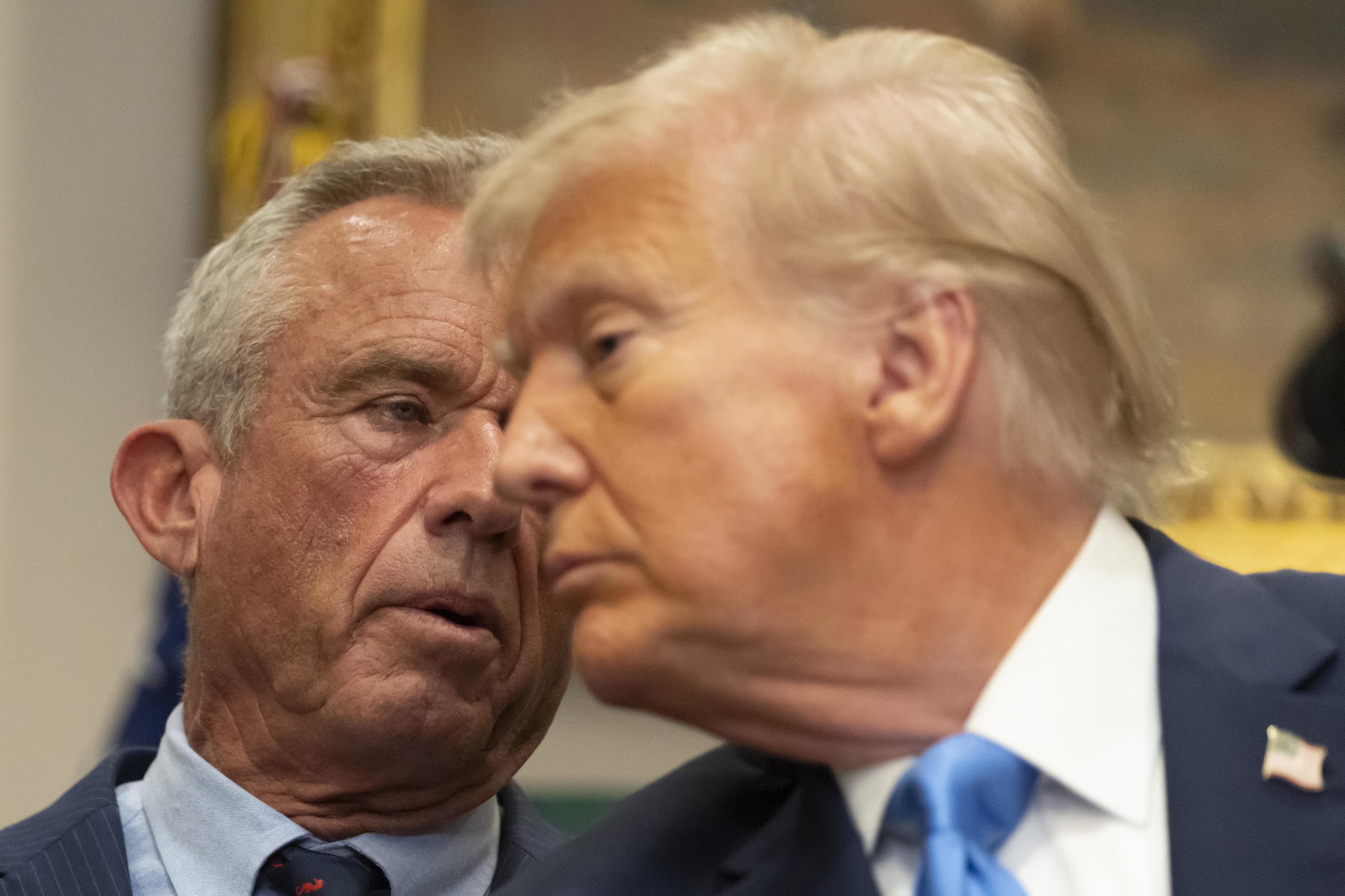 U.S. Secretary of Health and Human Services Robert F. Kennedy Jr. speaks with President Trump.