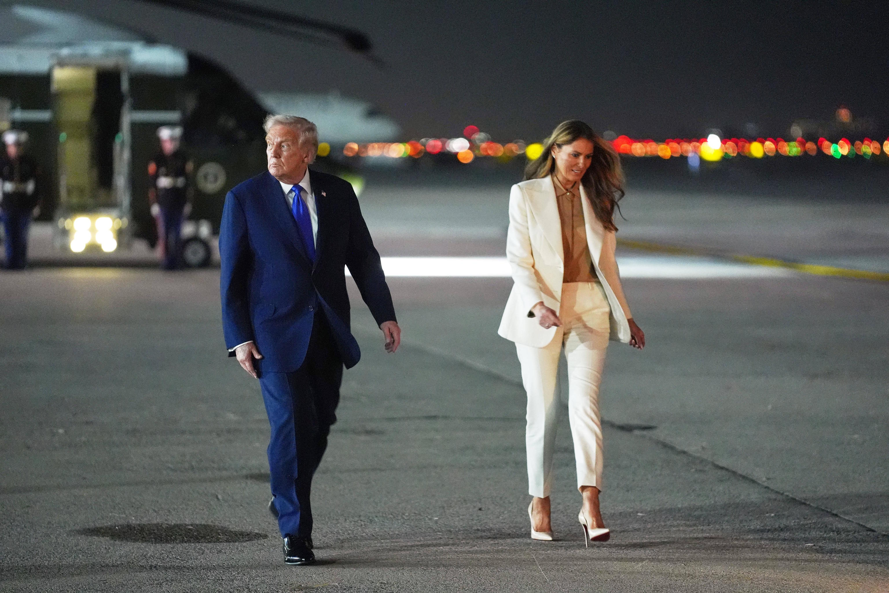 President Donald Trump and first lady Melania Trump, walk to board Air Force One.