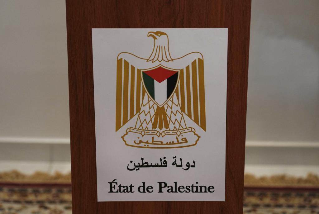 A sticker on a desk reads "State of Palestine".