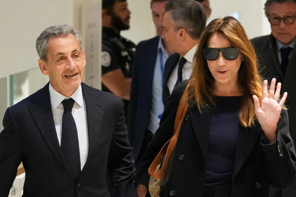 Former French President Nicolas Sarkozy, left, and his wife Carla Bruni, right, arrive at the courthouse