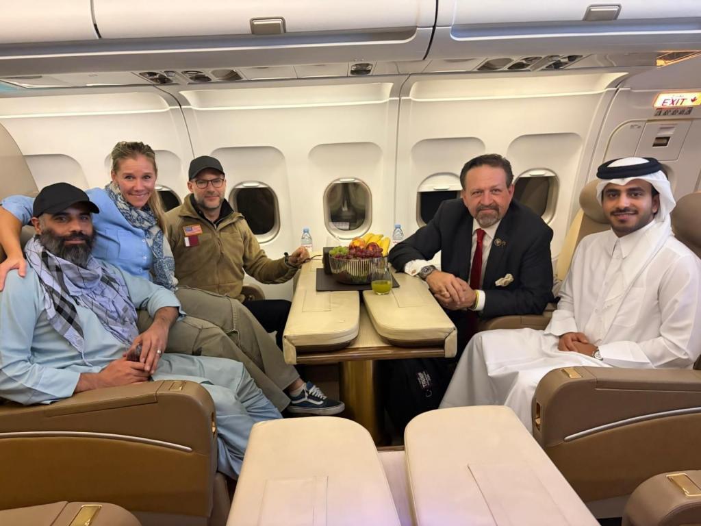 Citizen Amir Amiri, left, poses next to an unidentified woman, aboard a plane in Kabul, Afghanistan