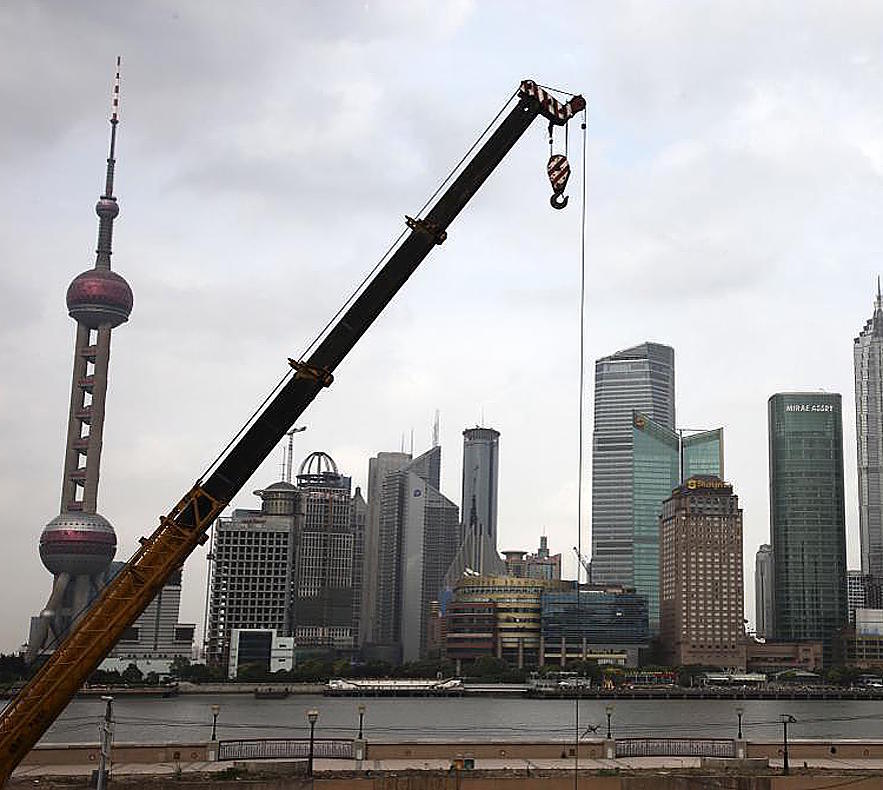 Crane in front of Shanghai skyscrapers.