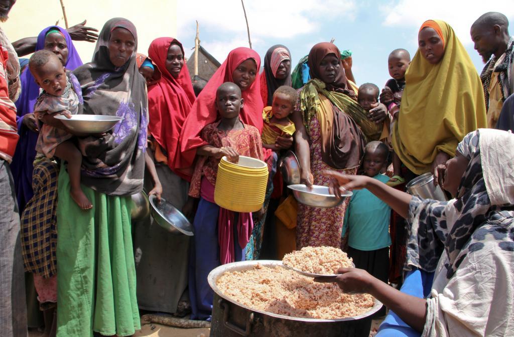 Newly arrived Somalis, displaced by a drought, receive food distributions at makeshift camps in the Tabelaha area on the outskirts of Mogadishu