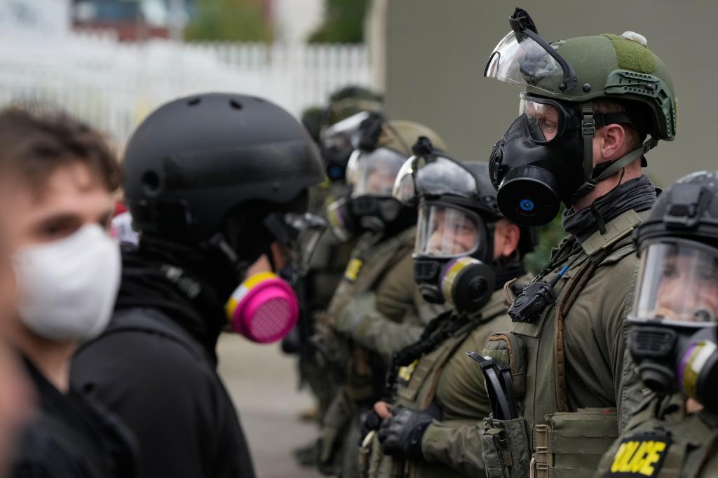 Law enforcement officers clash with protesters outside the U.S. Immigration and Customs Enforcement (ICE) facility.