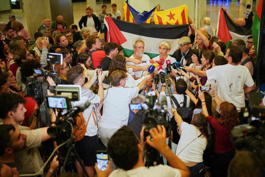 Former Barcelona mayor Ada Colau speaks with media as she arrives at the airport in Barcelona