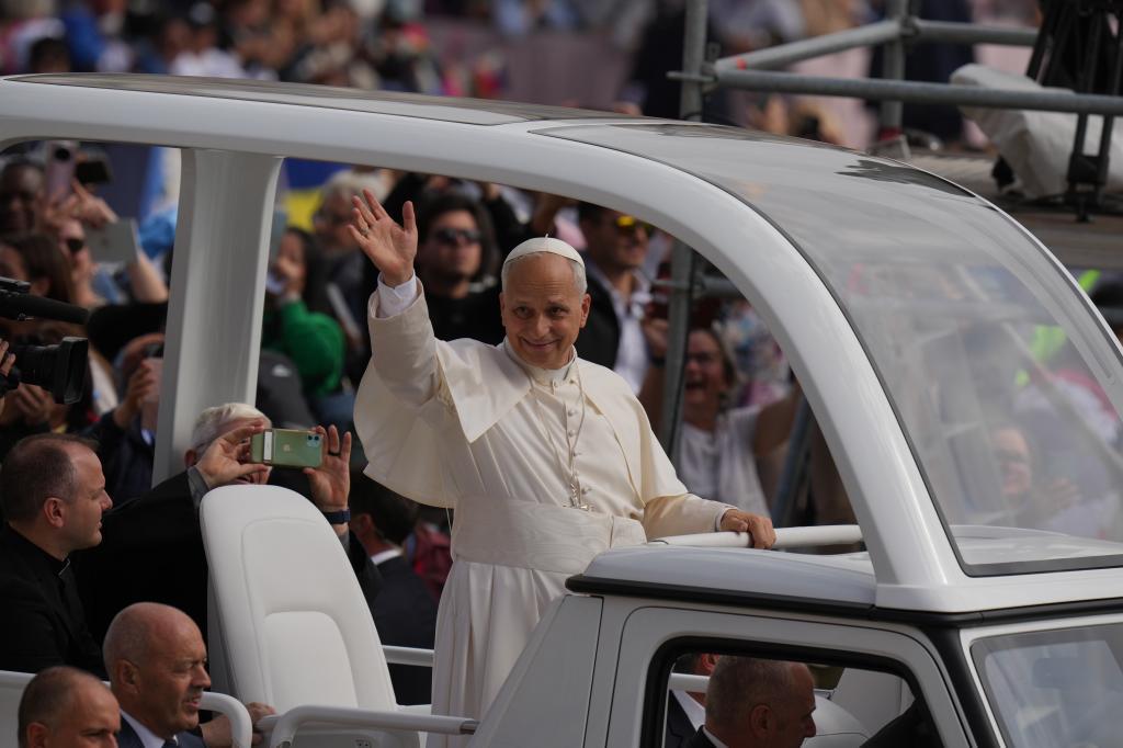 Pope Leo XIV waves from his popemobile.