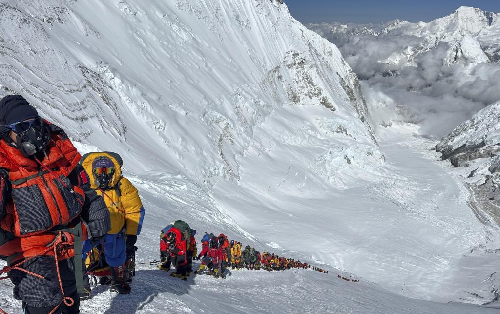 Mountaineers queue up below Camp 4 on the way to the summit of Mount Everest