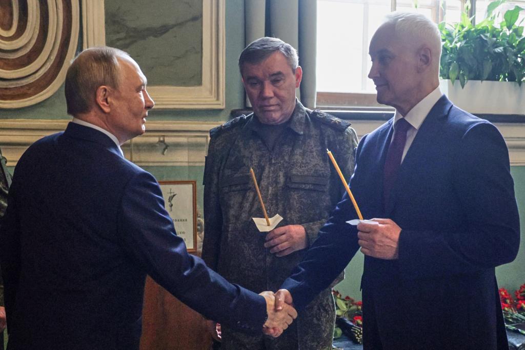 Russian President Vladimir Putin, left, shakes hands with Russian Defense Minister Andrei Belousov as Russian Army Chief of General Staff Gen. Valery Gerasimov