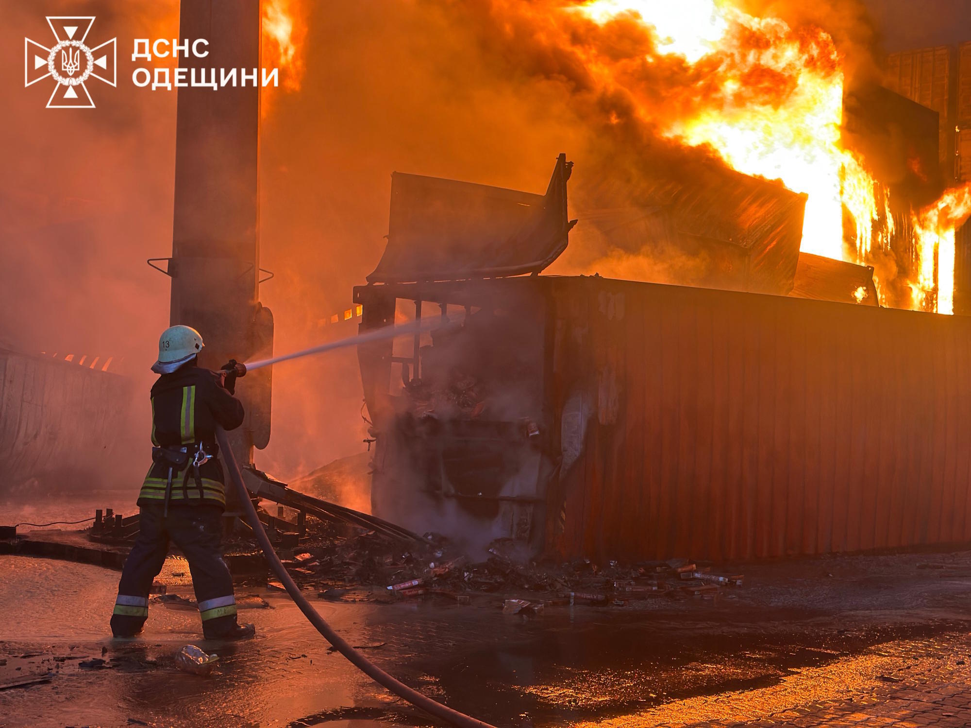 Emergency services work to extinguish a fire following a Russian attack.