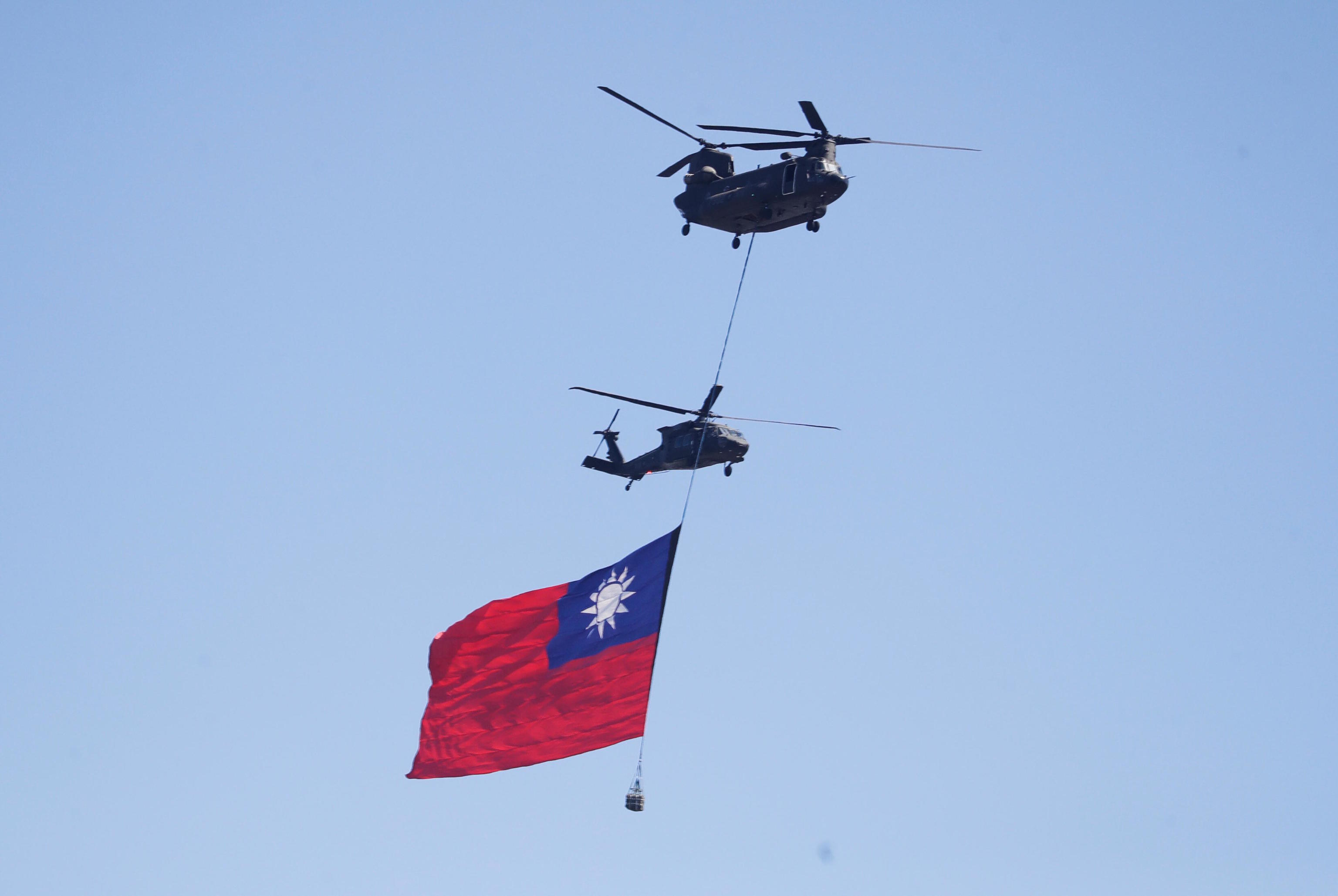 A helicopter with a national flag during National Day in Taipei.