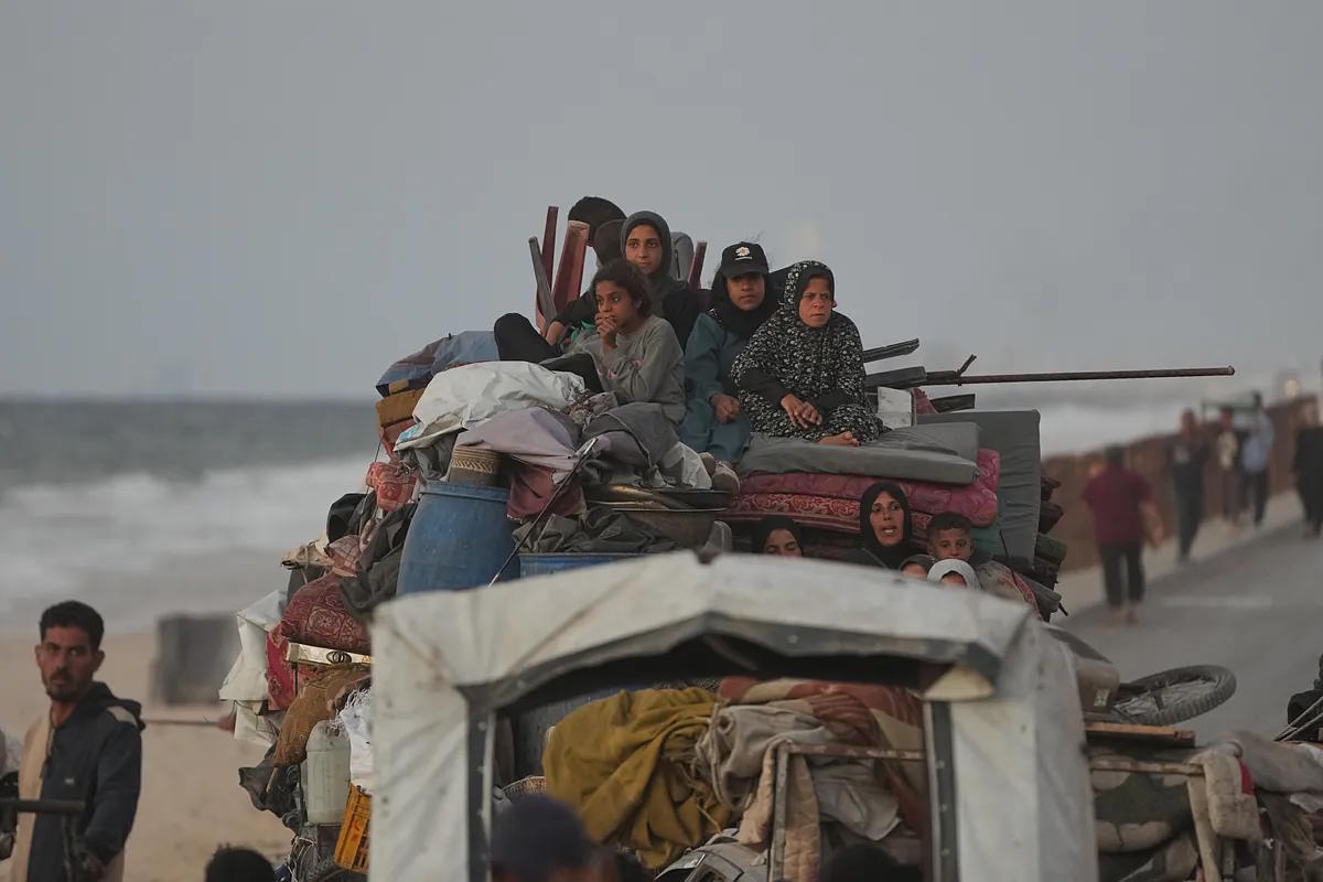 A Palestinian family travels in a truck with their belongings in the center of Gaza last Friday.