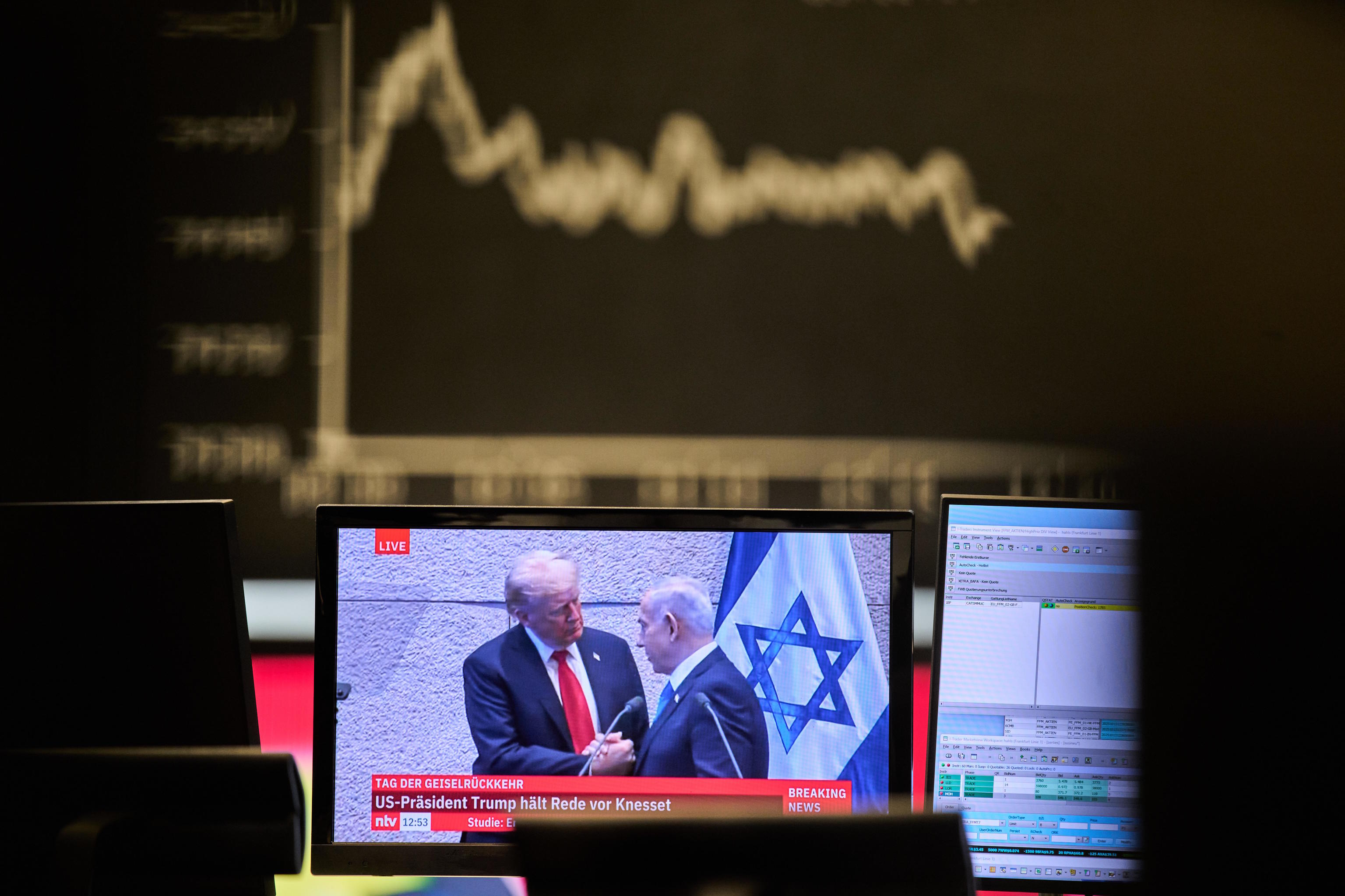 A television screen shows US President Trump and Israel's President Netanyahu.