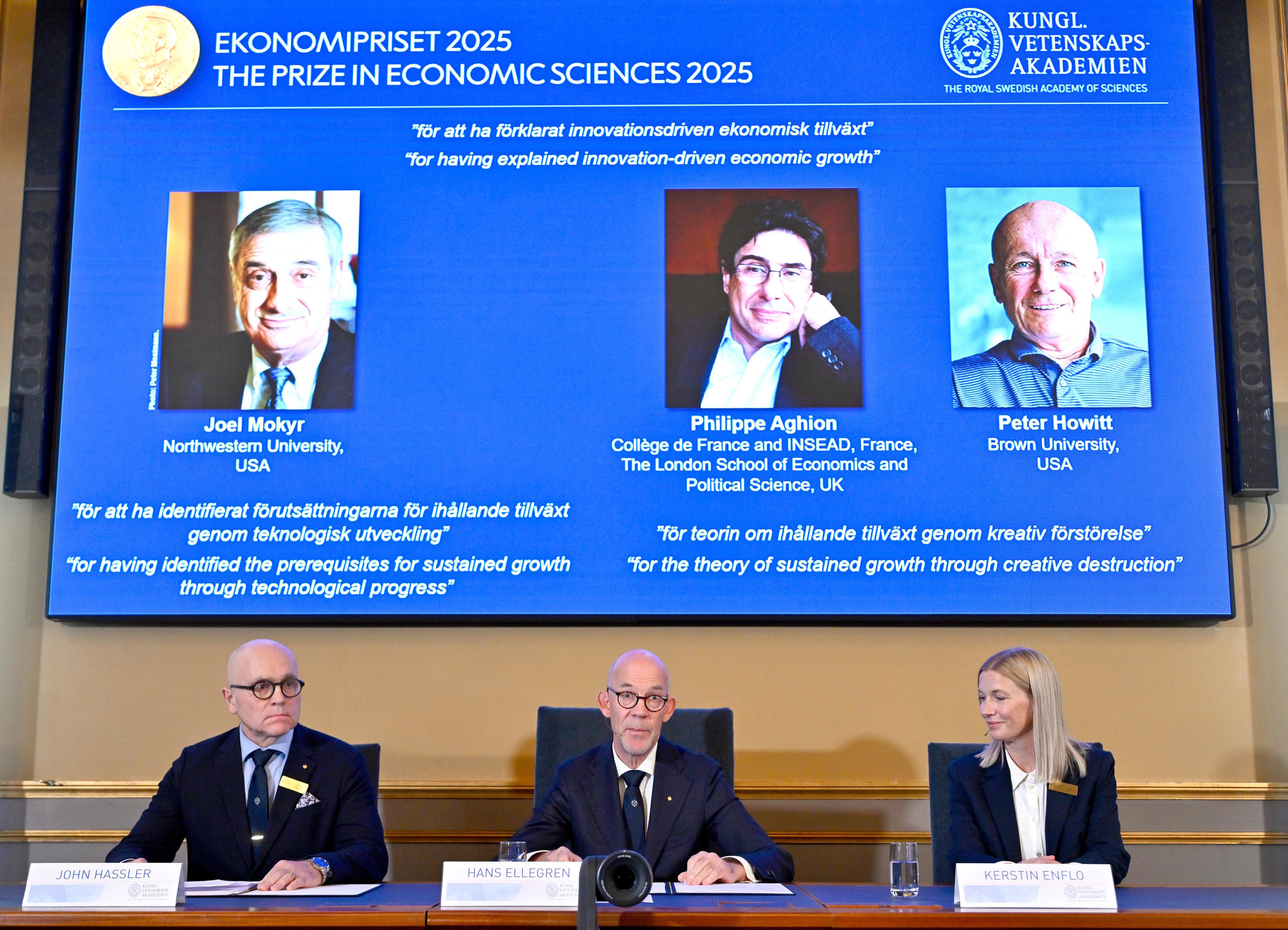 Committee members with the image of the awardees on the screen.
