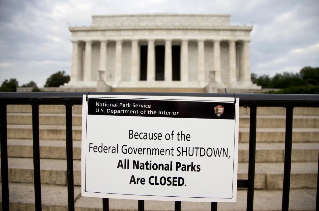 A sign reading "Because of the Federal Government SHUTDOWN All National Parks are Closed" is posted on a barricade in front of the Lincoln Memorial in Washington