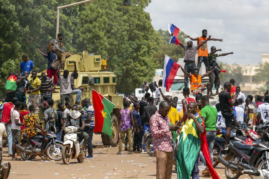 Supporters of Capt. Ibrahim Traore cheer with Russian flags in the streets of Ouagadougou, Burkina Faso,