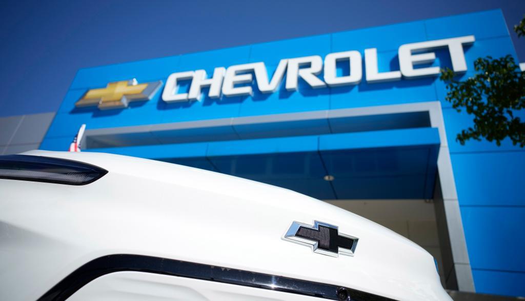 The company logo shines off the nose of an unsold 2022 Bolt electric vehicle