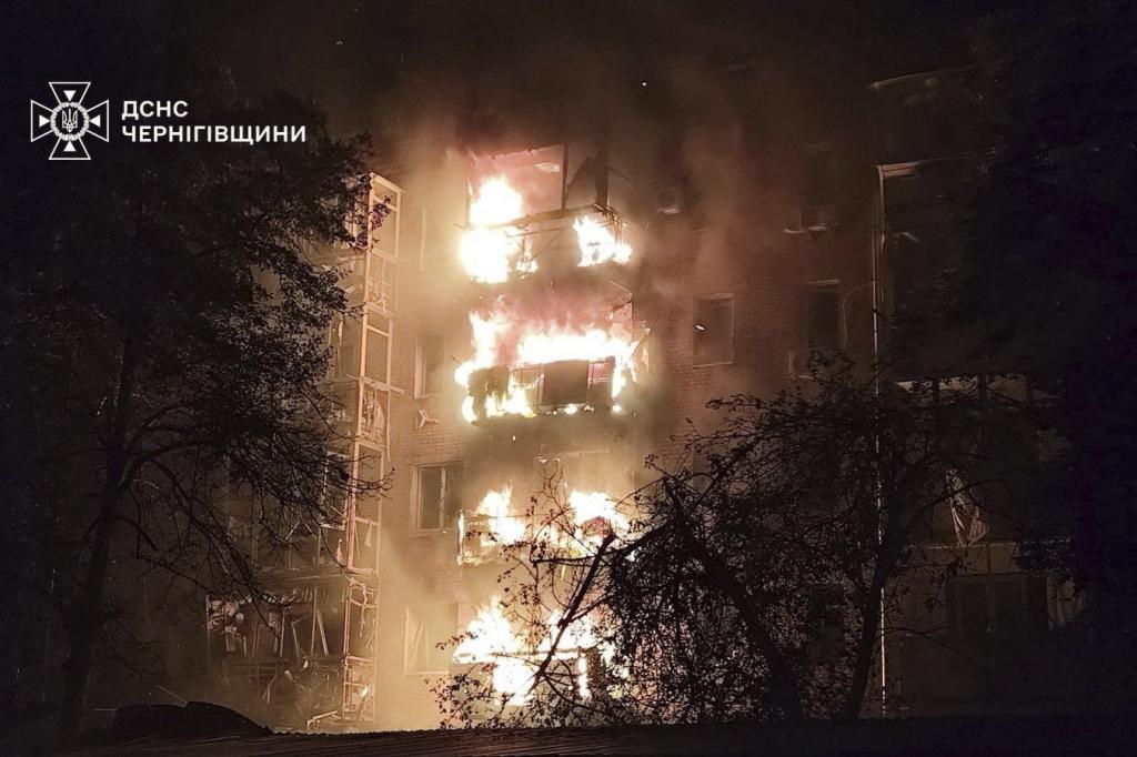 A residential building is seen on fire after a Russian strike in Nizhyn