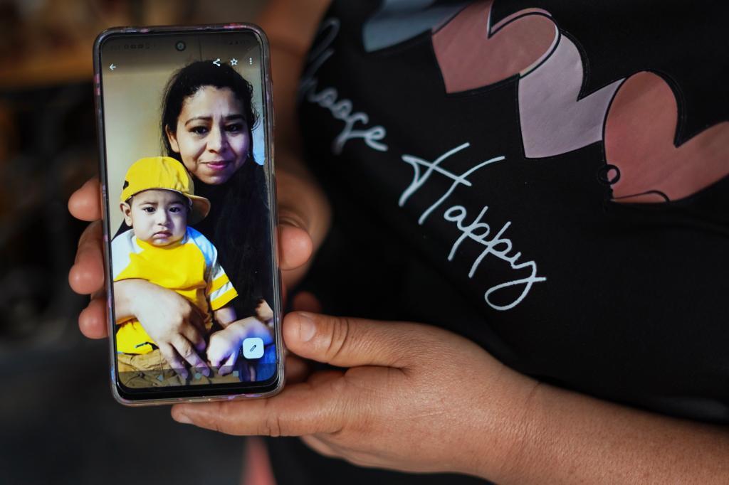 Carmen Gavidia Ramrez shows a portrait of her sister Maribel Ramrez and her nephew Evan, who died in a traffic accident in Jackson County