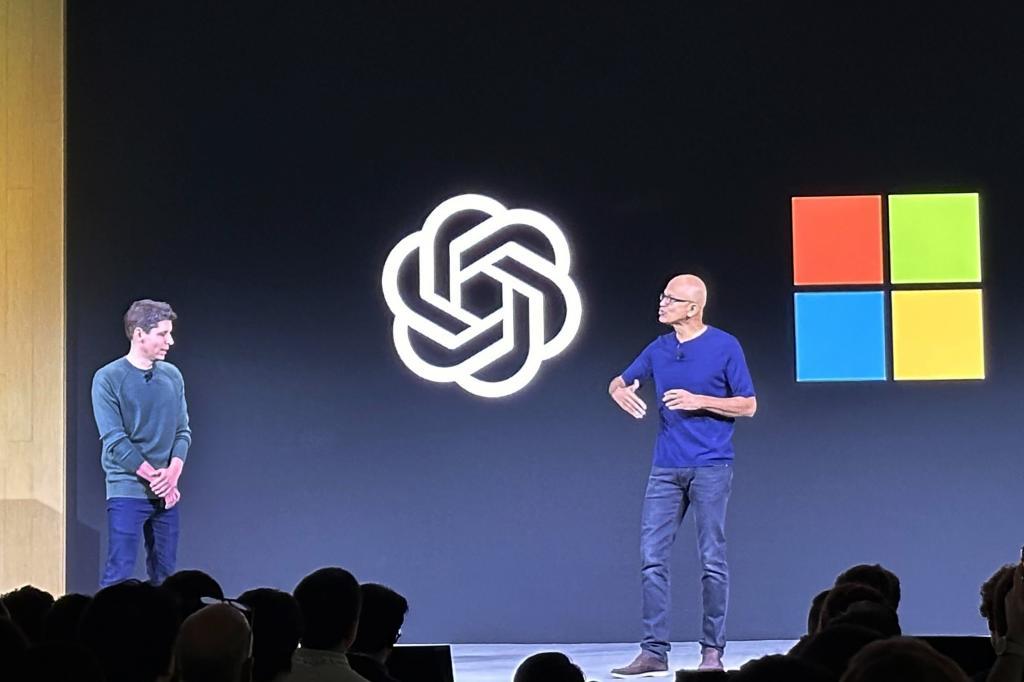 OpenAI CEO Sam Altman, left, appears onstage with Microsoft CEO Satya Nadella