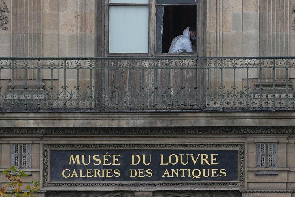 A police officer works inside the Louvre museum.