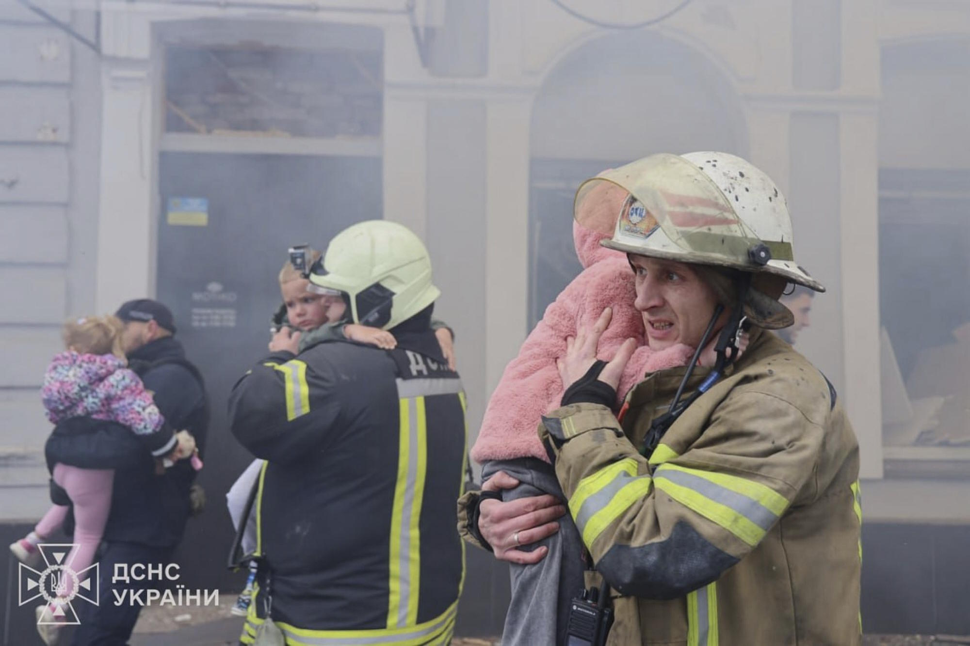 Rescuers evacuate children after Russian drones hit a city kindergarten.