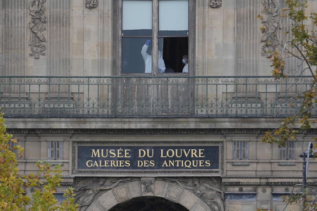 Police officers working inside the Louvre Museum