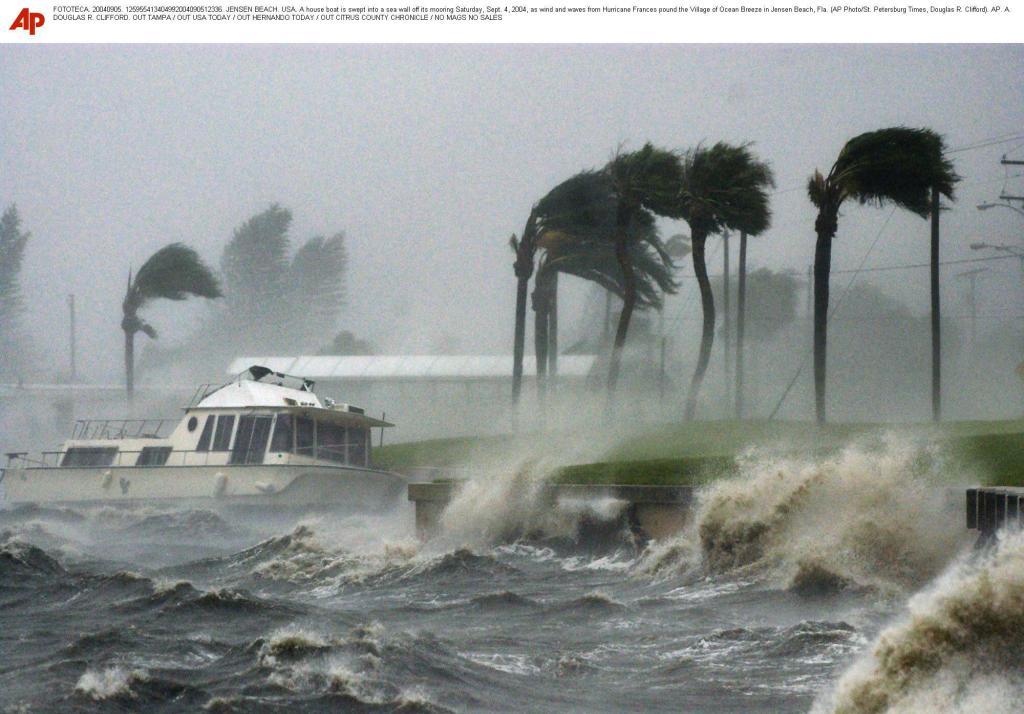 A house boat is swept into a sea wall off its mooring