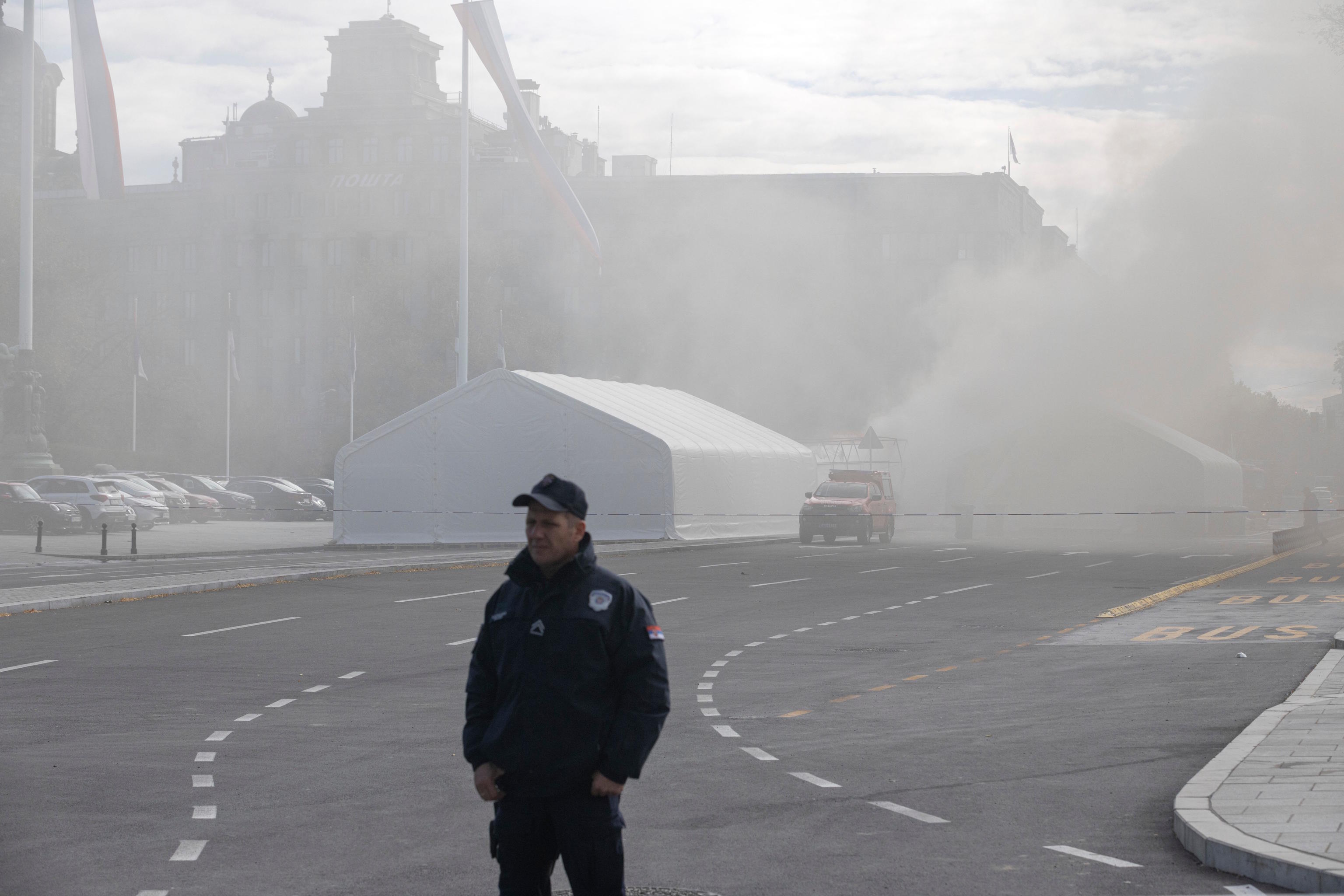 A policeman during a fire localized inside the government supporters' camp outside the Serbian parliament in Belgrade.