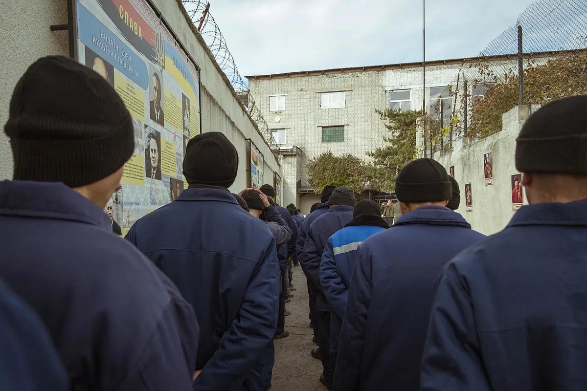 Prisoners line up to enter the prison dining hall.