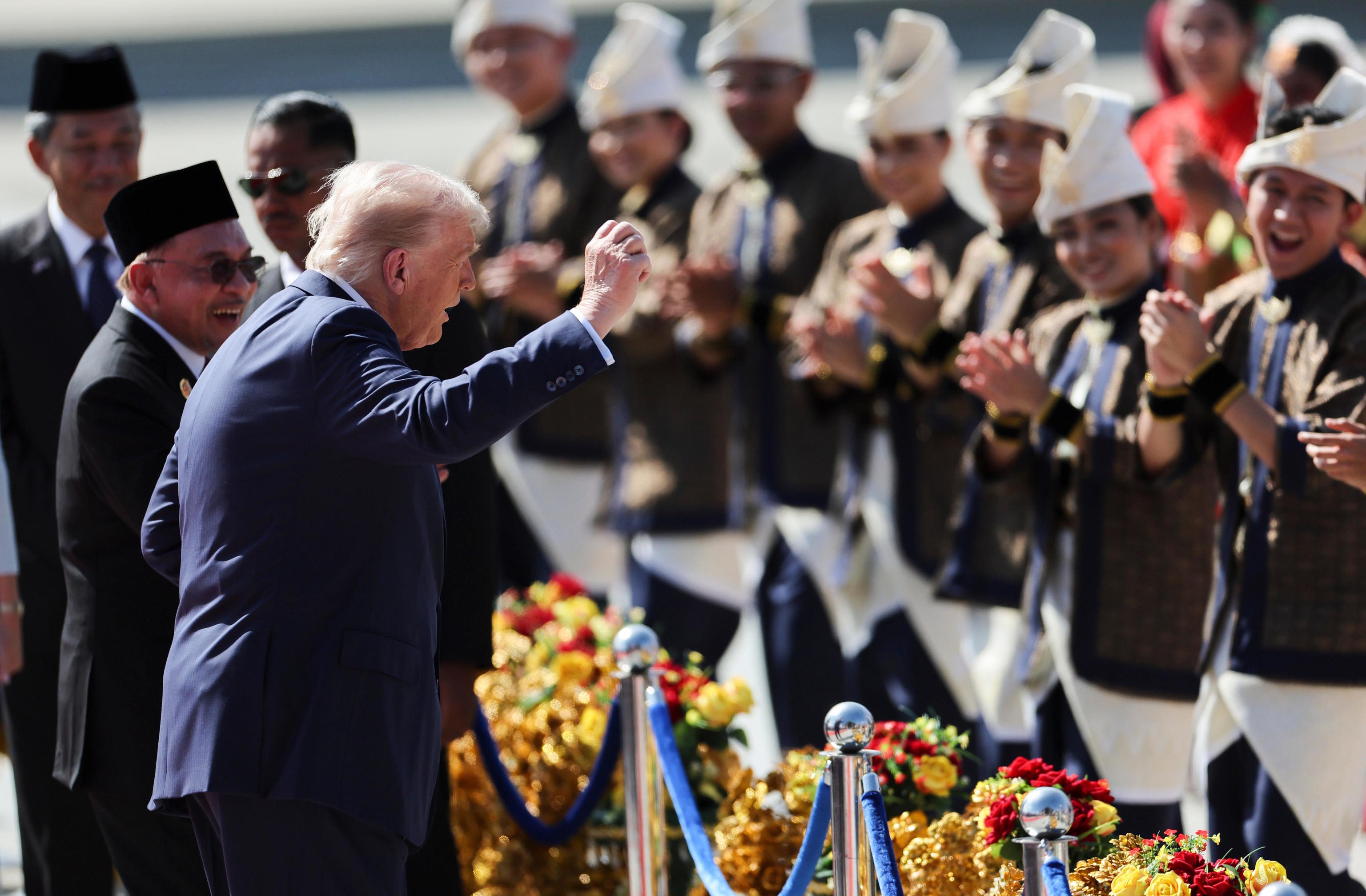 Trump reacts to during a welcoming ceremony at Kuala Lumpur Airport.