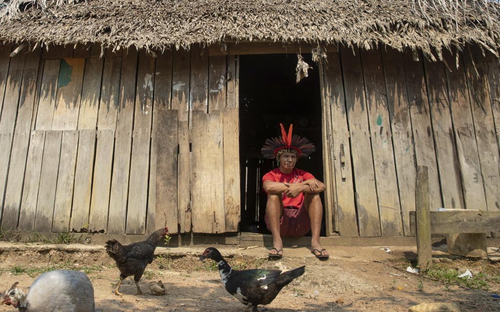 Indigenous leader Xavier Karitiana sits outside his home in Juari village, which is part of the Karitiana indigenous reserve near Porto Velho
