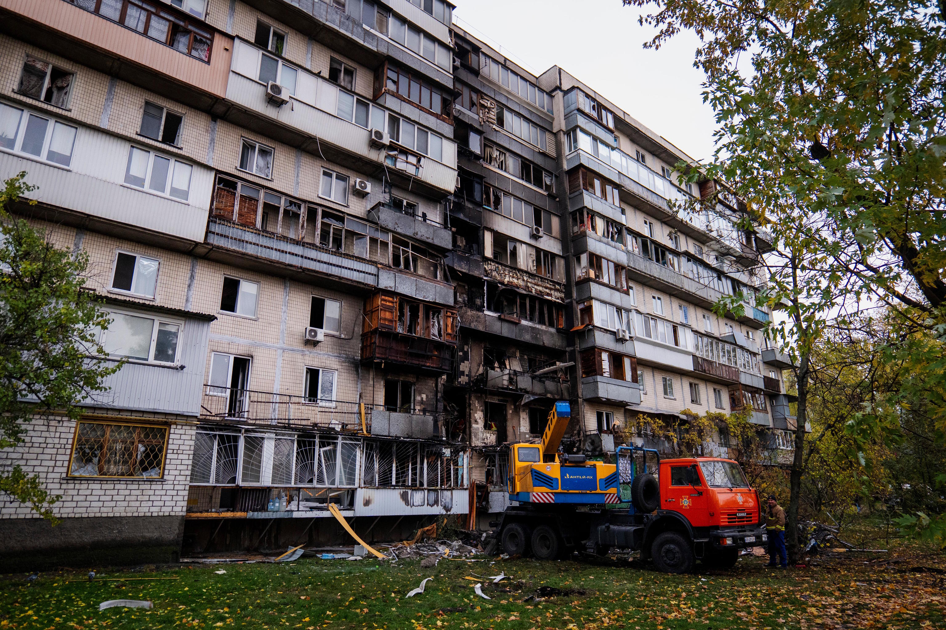 Firefighters work at a destroyed apartment building after a Russian drone attack in Kyiv.