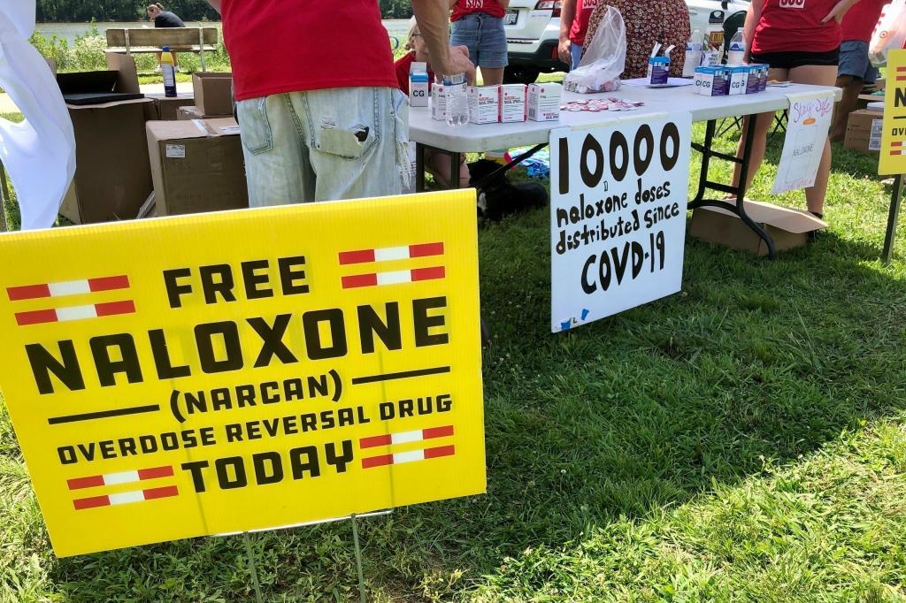 Signs are displayed at a tent during a health event