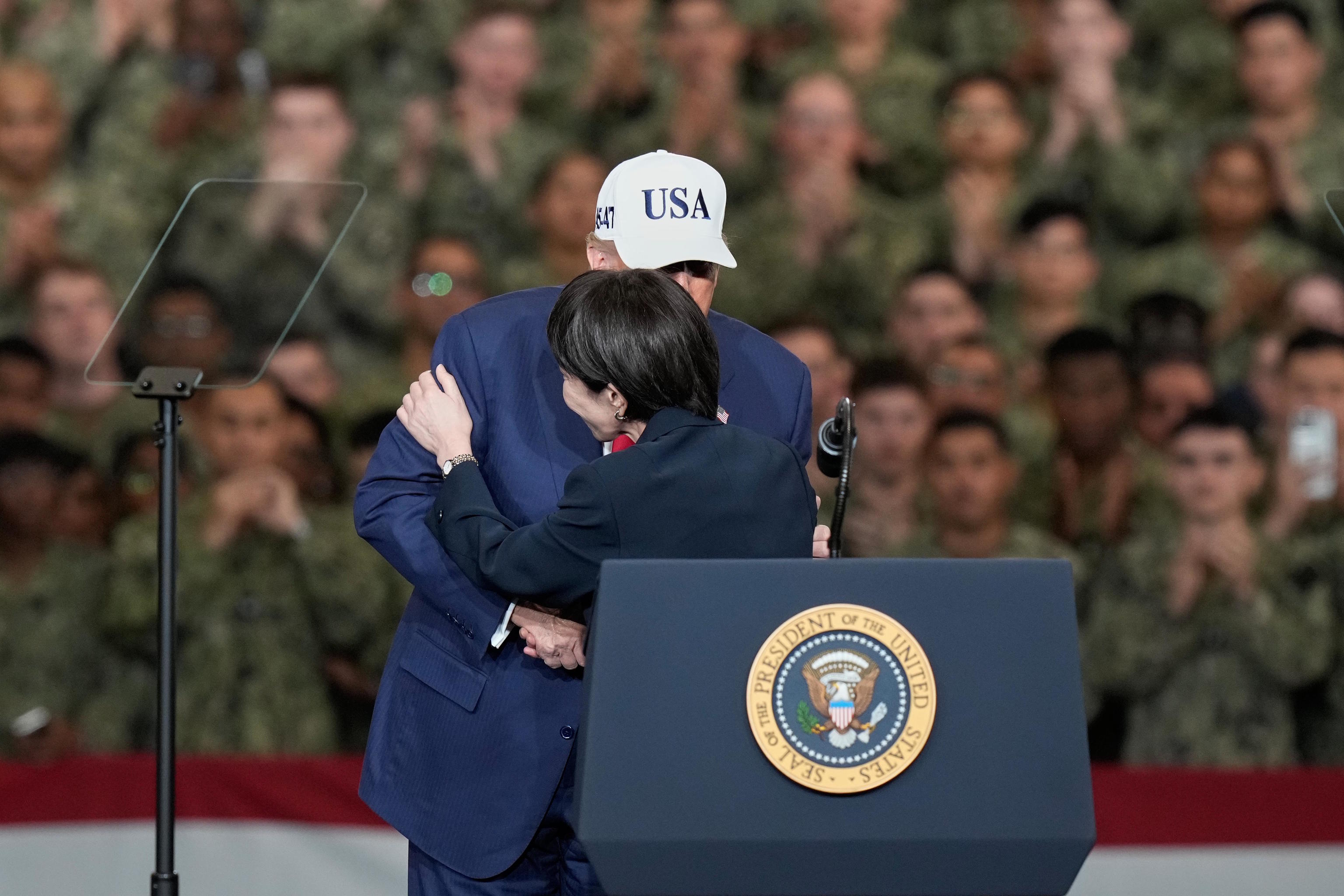 US President Donald Trump greets Japanese Prime Minister Sanae Takaichi.