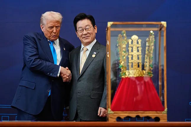 US President Donald Trump shakes hands with South Korean President Lee Jae Myung.
