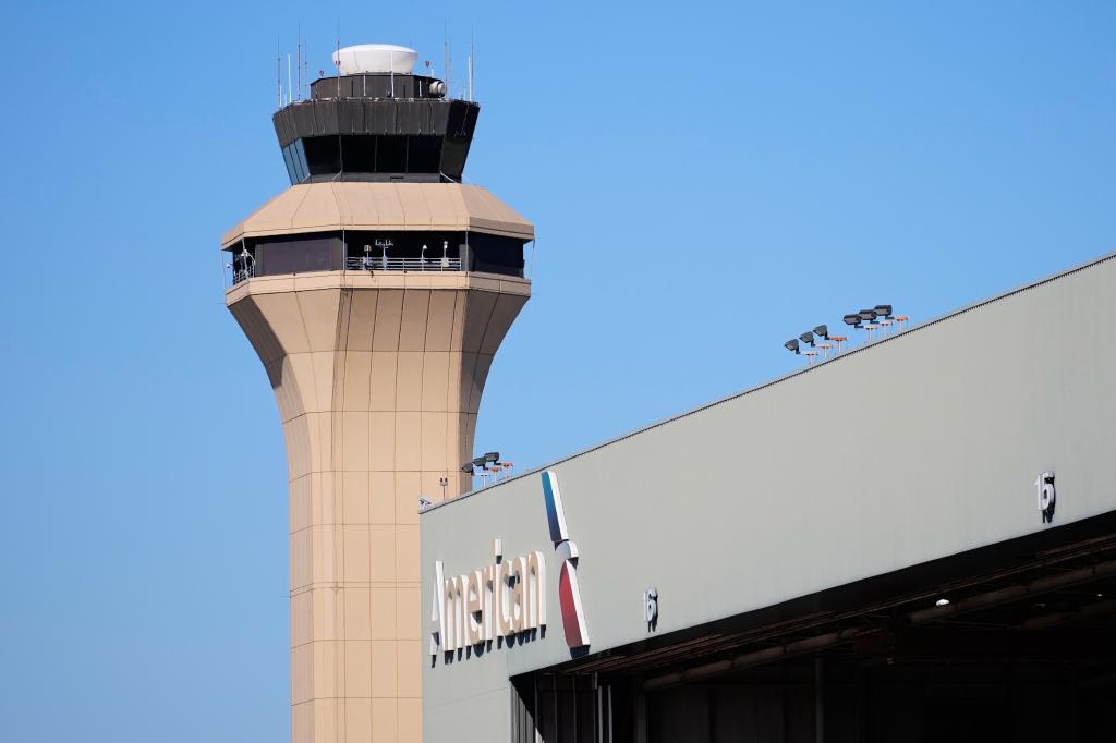A control tower by an American Airlines hangar is shown at Dallas Fort Worth International Airport