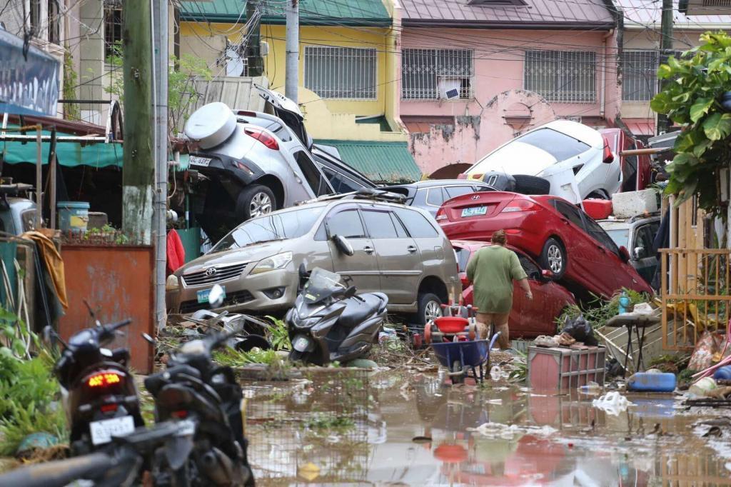 Vehicles lie piled on after flooding caused by Typhoon Kalmaegi in Cebu city