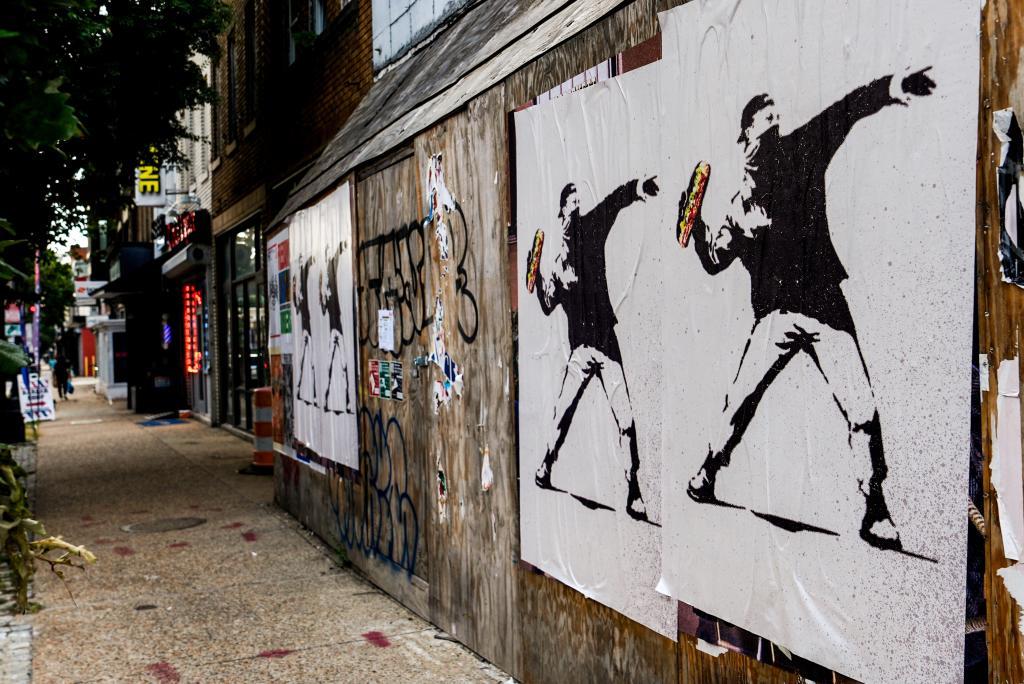 Posters of a person throwing a sandwich are pictured along H Street