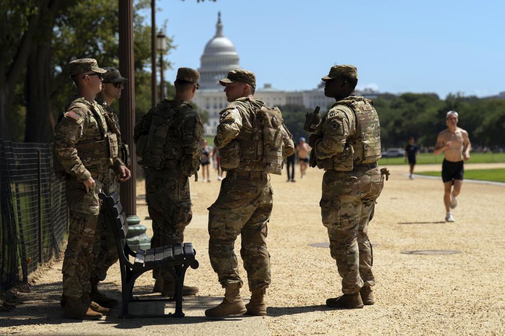 With the U.S Capitol in the background, members of the District of Columbia National Guard patrol the National Mall