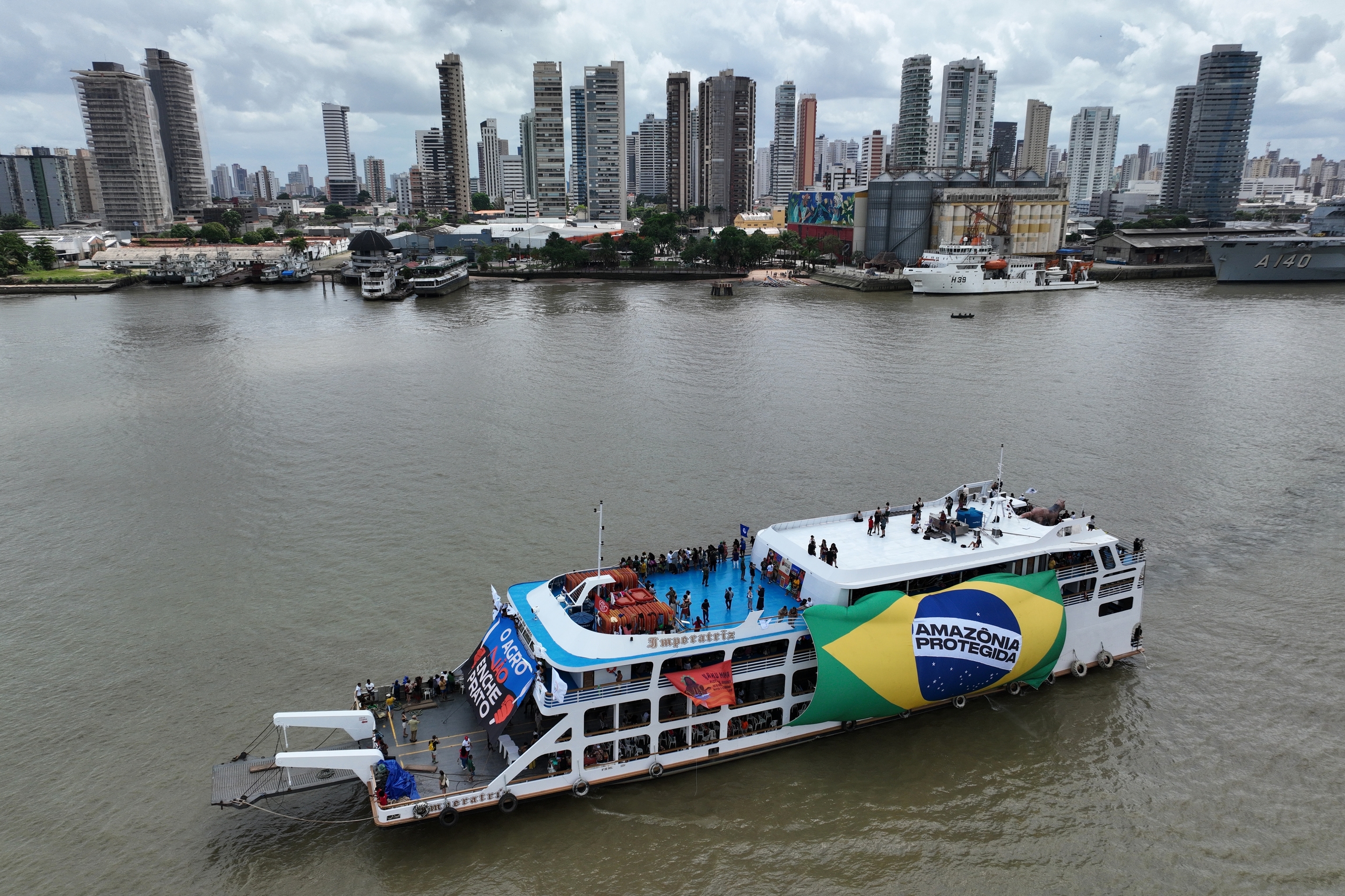 People riding in a boat participate in a People's Summit.