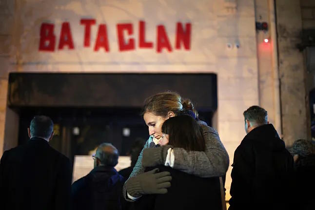 Two women embrace in front of the Bataclan concert hall in Paris.