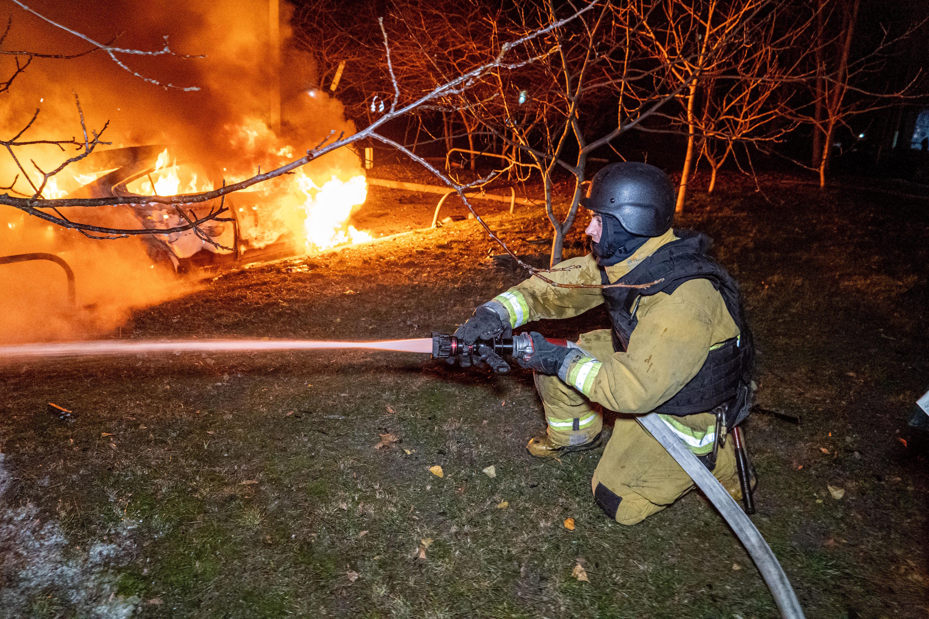 Rescue workers put out a fire by a Russian strike on Kharkiv.