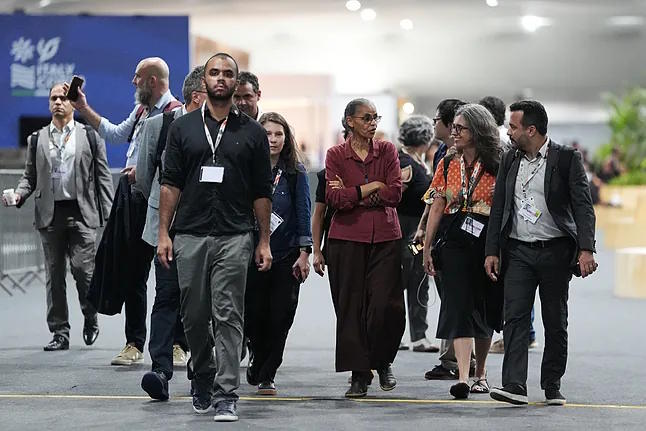 Brazilian Minister of the Environment, Marina Silva, walks with delegates .